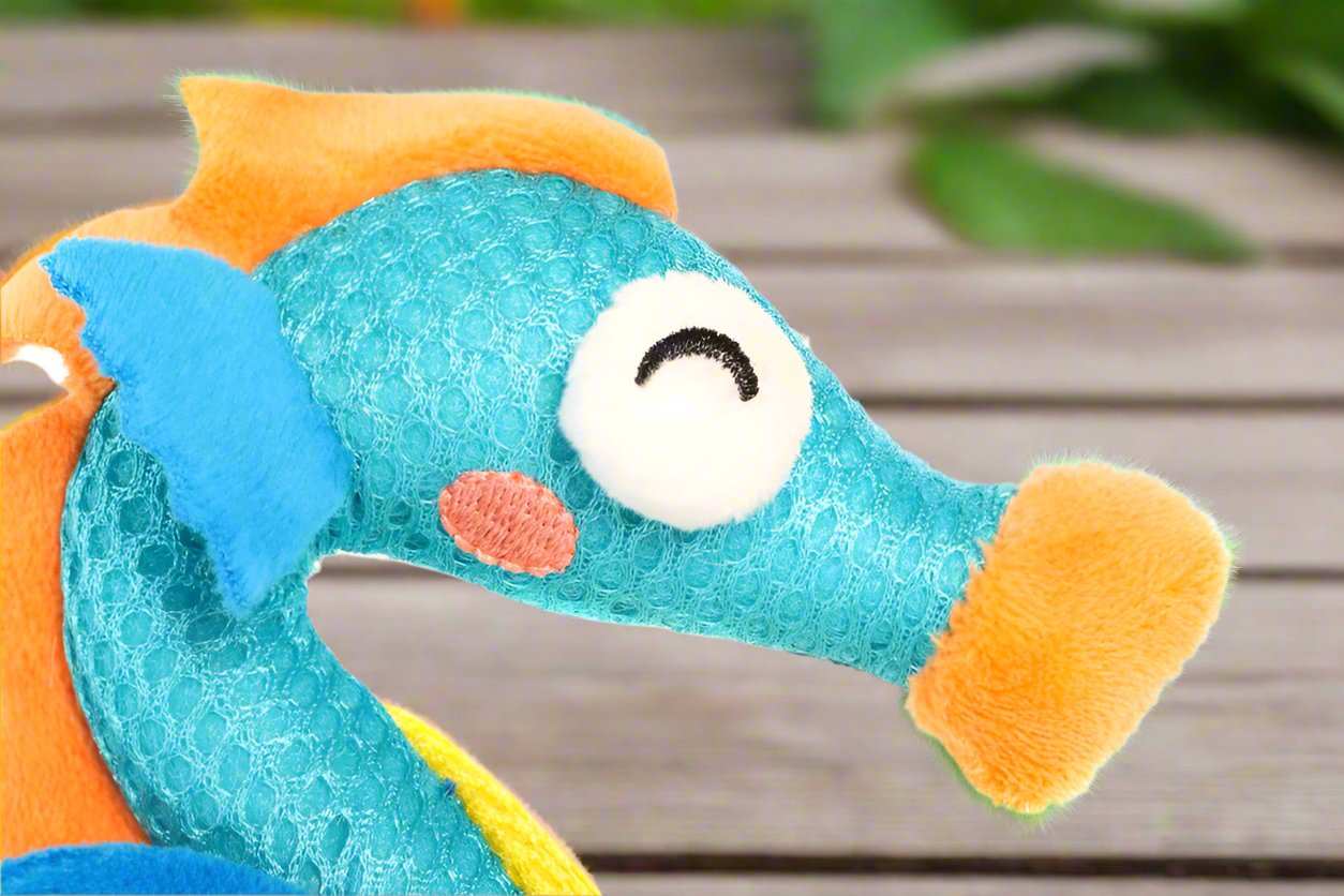 GiGwi Dental Mesh Catnip Seahorse toy for cats, featuring a seahorse-shaped design with a textured mesh surface, bright colors, and a catnip scent. The toy is designed to help clean cats' teeth while they play.