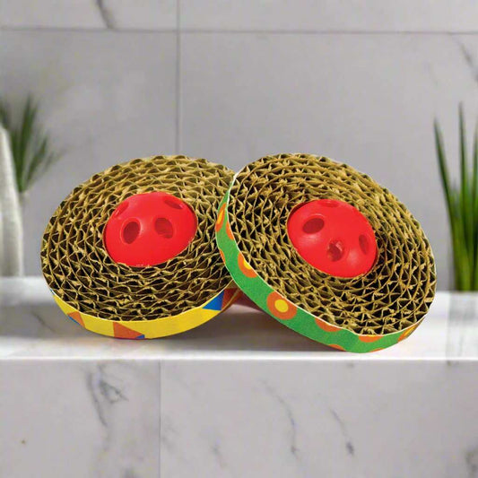 Spin & Scratch Cat Toys from Petstages featuring colorful corrugated discs and jingle balls. The interactive toy set includes a spinning corrugated disc for scratching and jingle balls that bounce and roll, designed to engage cats in playful batting and chasing while redirecting scratching behavior away from furniture.