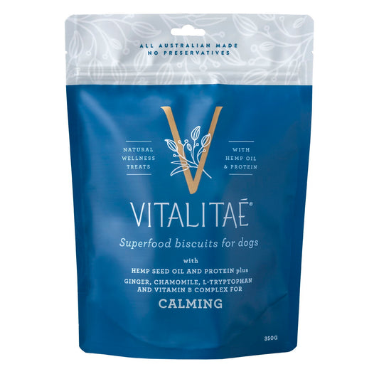 A calm and relaxed dog sitting after being given Vitalitae calming biscuits.

